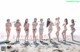 A group of women standing on top of a sandy beach.